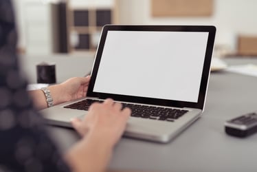 a person typing on a laptop computer