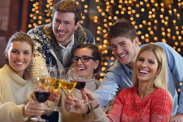 Group of happy young people drink wine at party disco restaurant