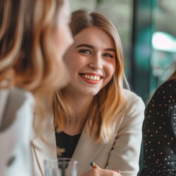 Woman among co-workers smiles happily at the camera