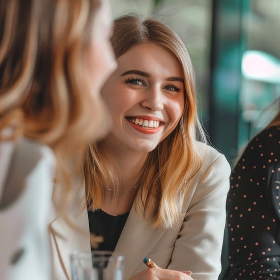 Woman among co-workers smiles happily at the camera