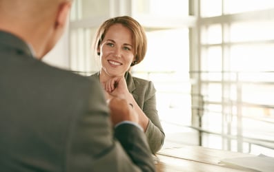 Two co-workers at table discussing plan