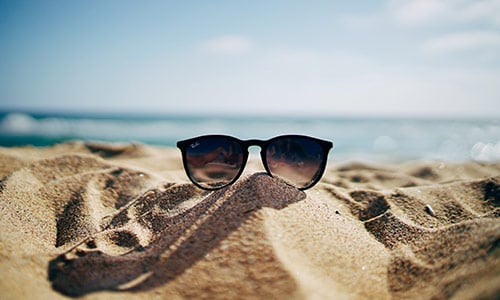 sunglasses on a sandy beach