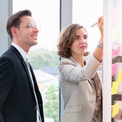 man and women holding a strategy session