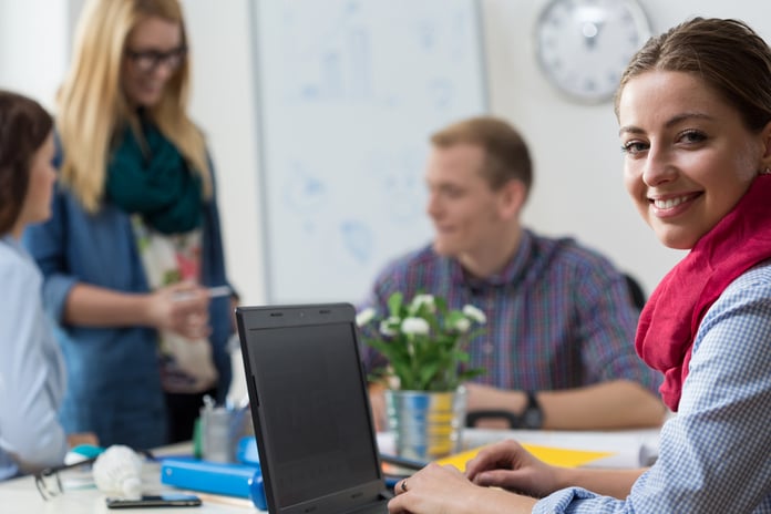 Portait of smiling young intern at office-2