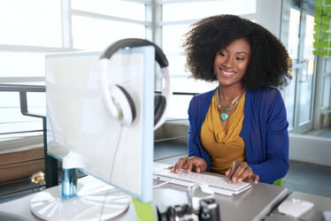 woman coding on a desktop computer