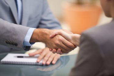 upclose of two people shaking hands