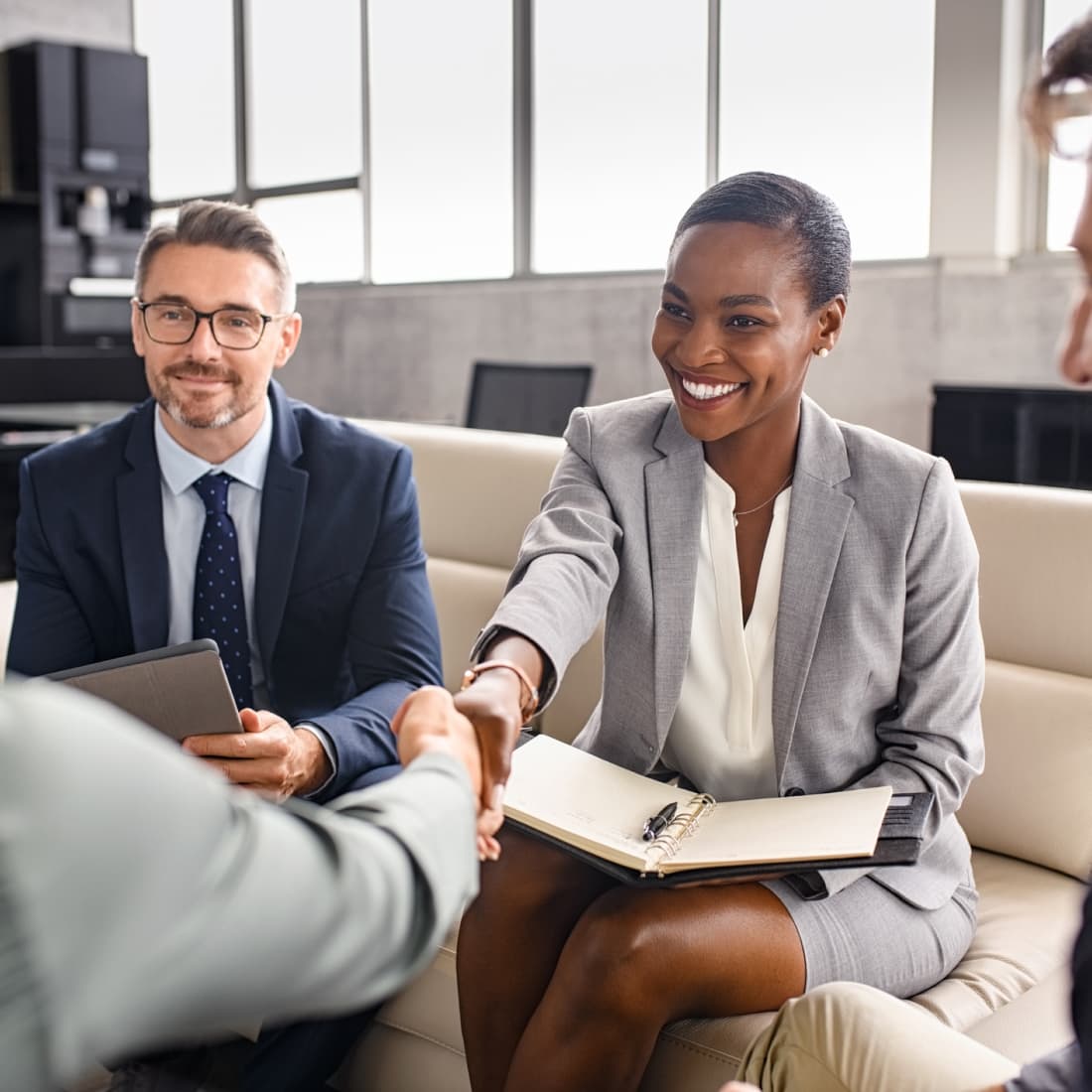 Business woman shaking hands with man during meeting. 