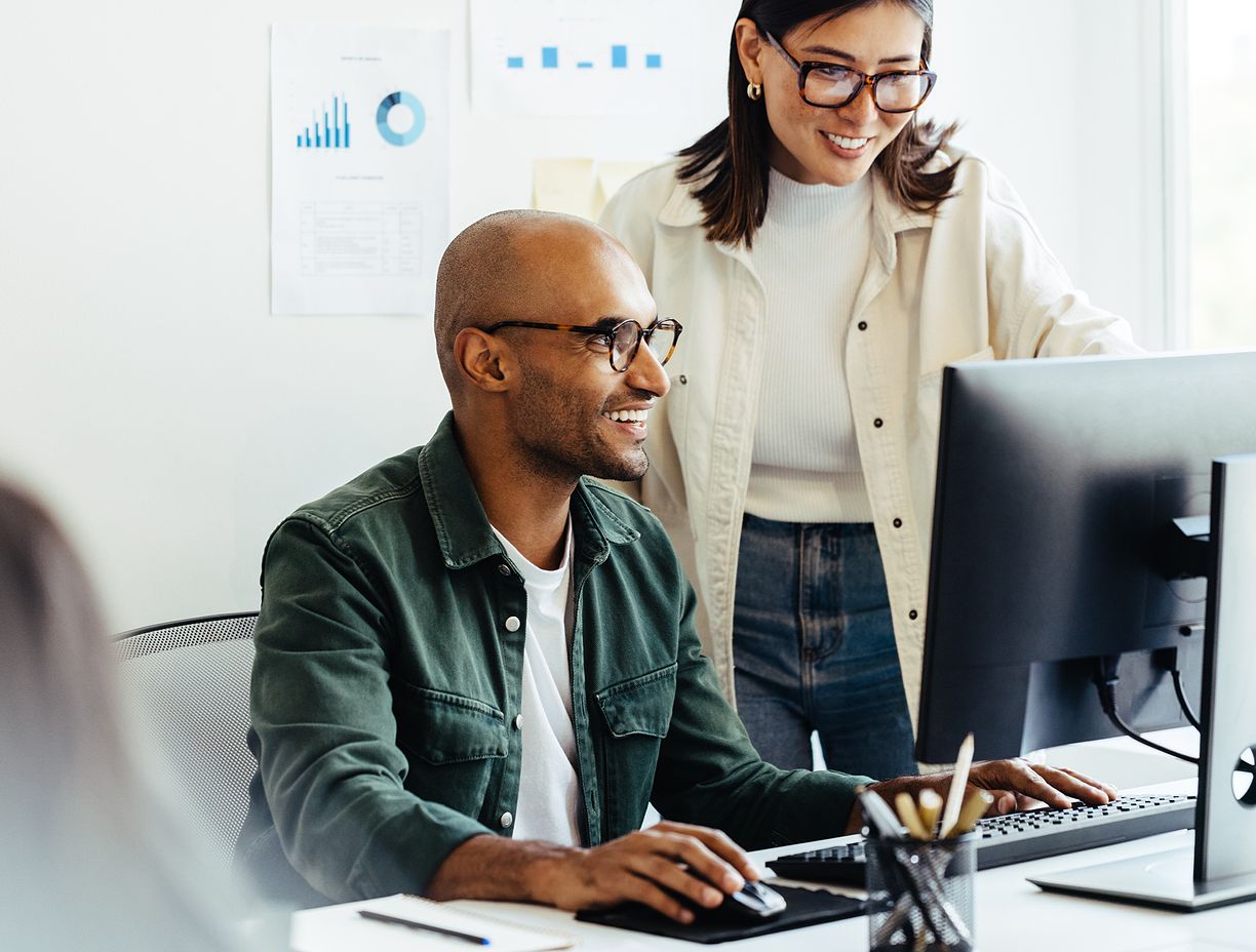 Professional helping client on computer. 