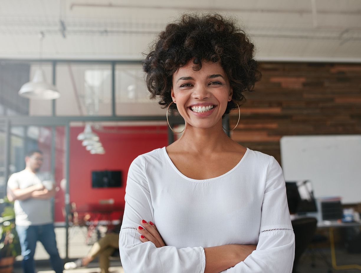 Woman smiling with her arms crossed. 