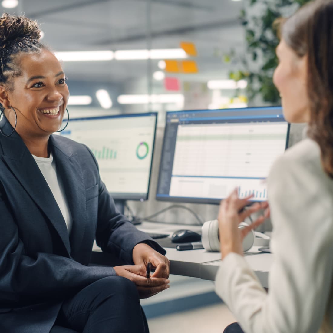 Two employees conversing with one another. 